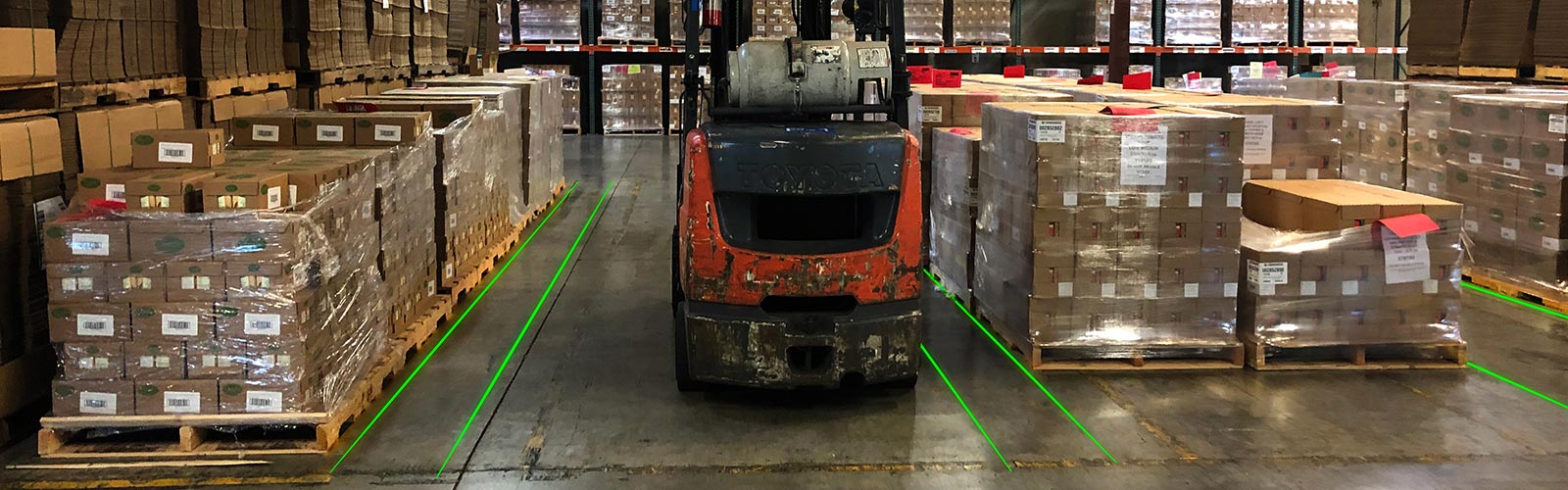 Laser lines marking staging lanes in a warehouse